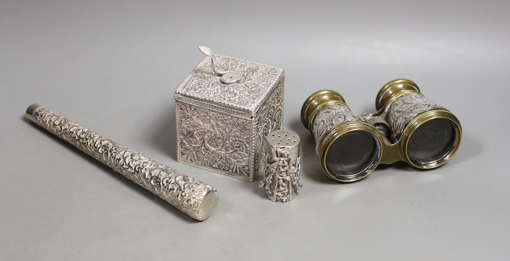 A late Victorian Indian silver box and cover, with serpent finial, import marks for London, 1898, 9cm, a Chinese Export white metal condiment, a pair of late Victorian silver mounted opera glasses and a white metal paras